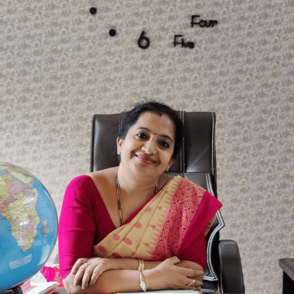 Principal Durga Giri.D at her desk, a compassionate educator dedicated to creating a joyful learning environment at GDP.