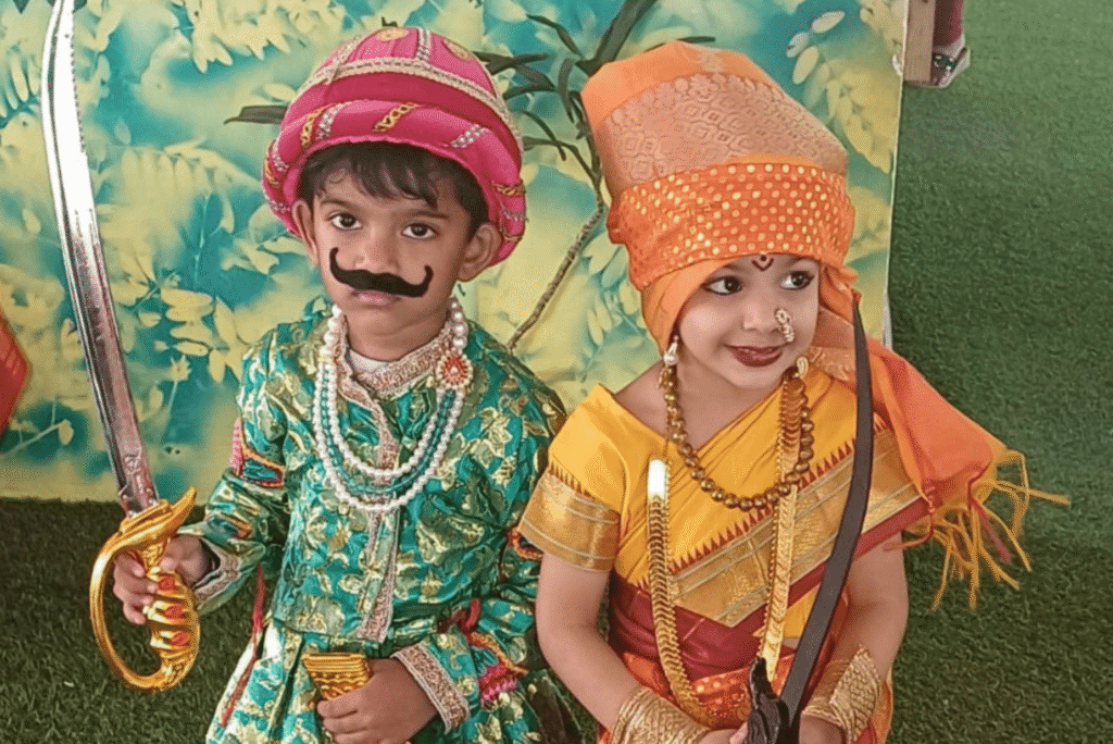 Two young students dressed in traditional warrior costumes for a cultural event at Guru Dronacharya Pathshala.